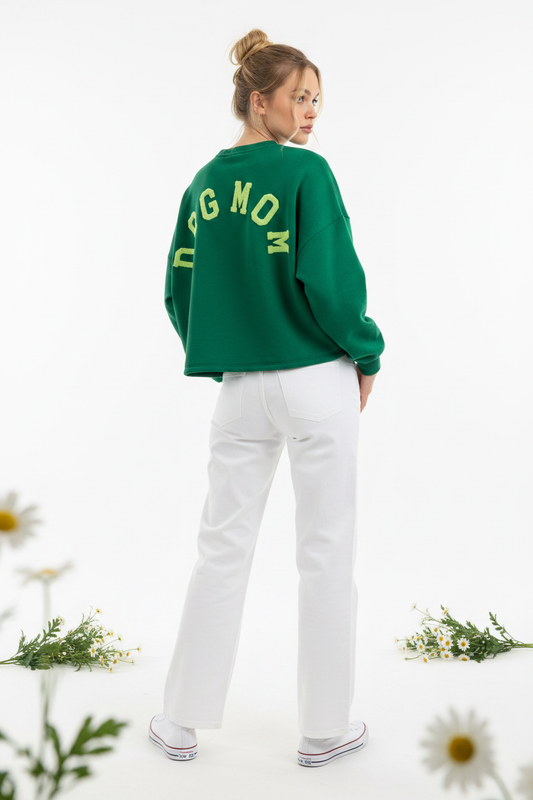 Model draagt het DOGMOM Oversized Sweatshirt in groen met groen geborduurd logo op de rug
